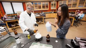 students in lab with chemicals doing experiment